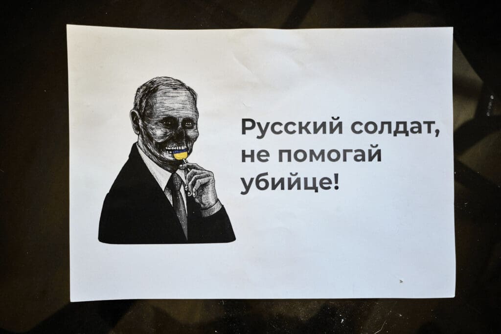 Flyer in Maria's house reading " Russian soldiers do not help a murderer"- Tbilisi, August 2023